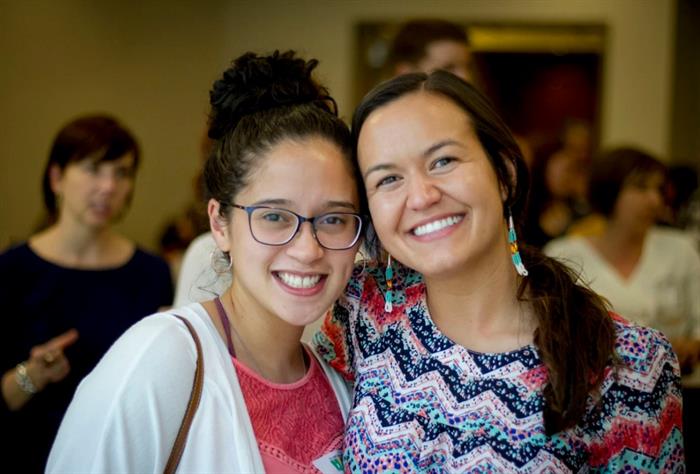 Twowomensmilingatthecamera