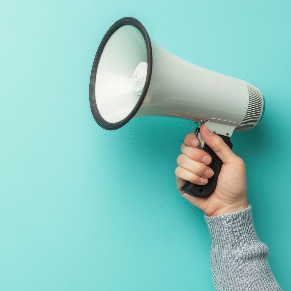 A hand holding a megaphone.