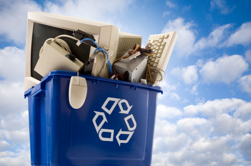 Picture of a recycle bin with old computers in it.