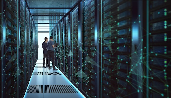 Two men looking at storage servers in a blue tinted room Two men looking at storage servers in a blue tinted room