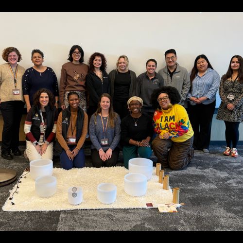 Happy attendees pose for a group photo during the 2026 VOICE wellness social.